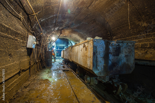 Underground gold mine shaft tunnel drift with orecarts wagons