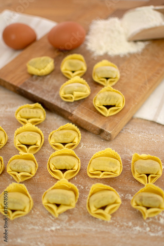 Italian traditional hoemade pasta tortellini with spinach and ricotta, selective focus photo