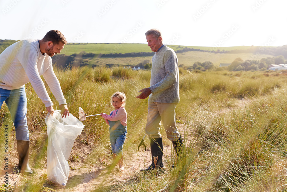 Multi-Generation Family Collecting Litter On Winter Beach Clean Up Multi-Generation Family Collecting Litter On Winter Beach Clean Up