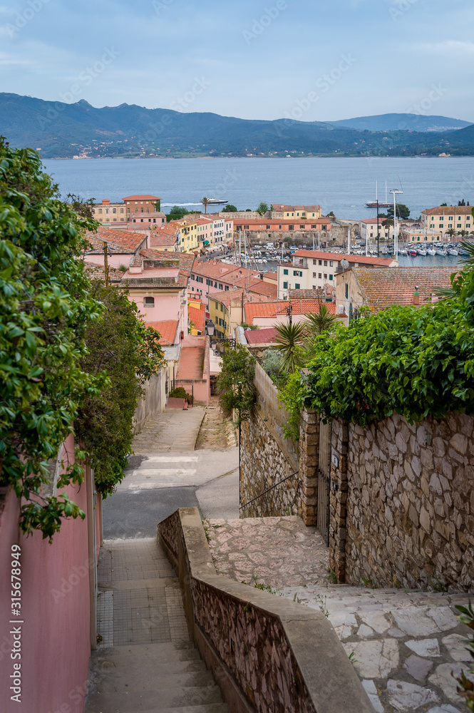 Tiny street goes down to Potriferraio port, Elba island, Italy
