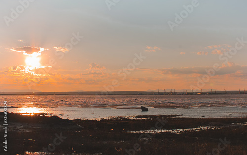  ice on the coast of the river at sunset photo
