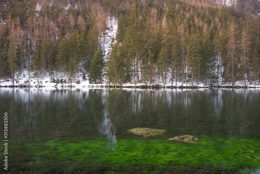 Green lake (Gruner see) in sunny winter day. Famous tourist destination for walking and trekking in Styria region, Austria