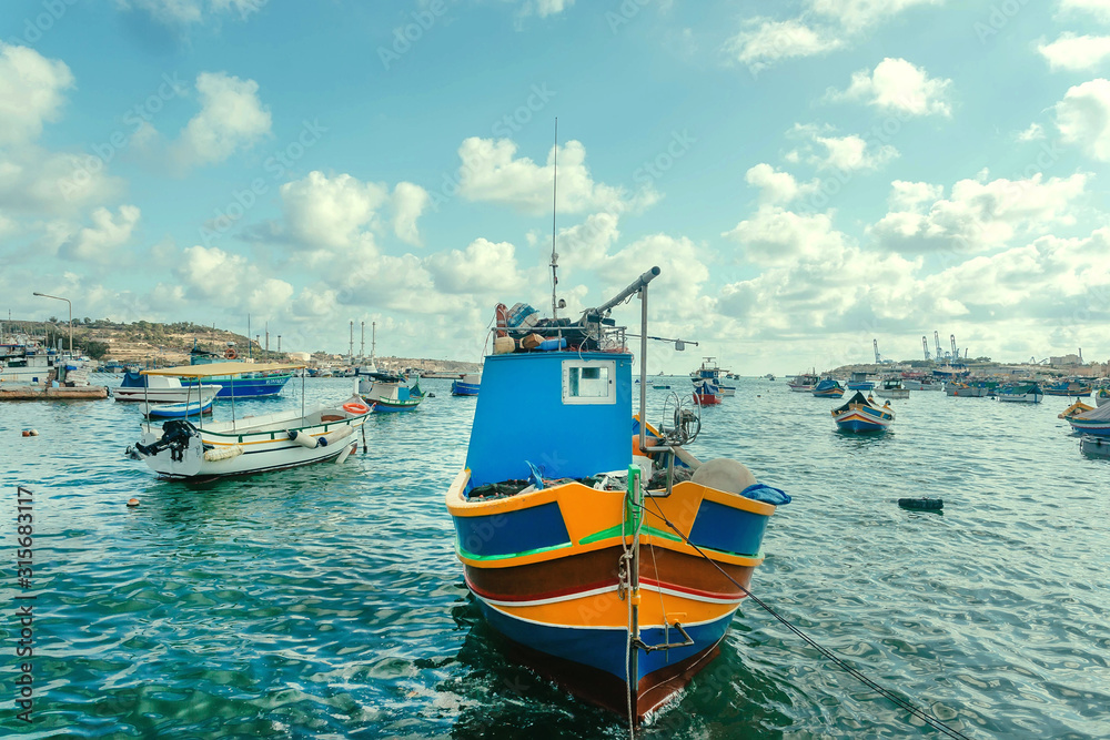 Colorful harbor with fishermen boats under bright sun
