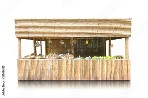 Exotic tropical retail kiosk with fruits and vegetables or tiki hut or beach bar isolated on white background, clipping path included