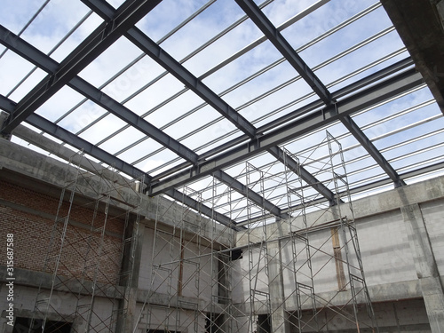 Wallpaper Mural KUALA LUMPUR, MALAYSIA -JUNE 16, 2019: Lightweight roof trusses under construction at the construction site. Installed properly by workers to received the roof covering system.  Torontodigital.ca