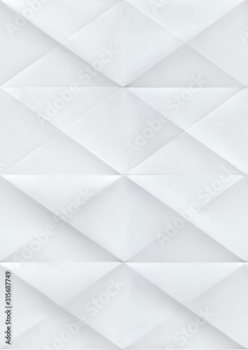 Paper folded in rhombuses. Seamless pattern with a white paper texture folded.