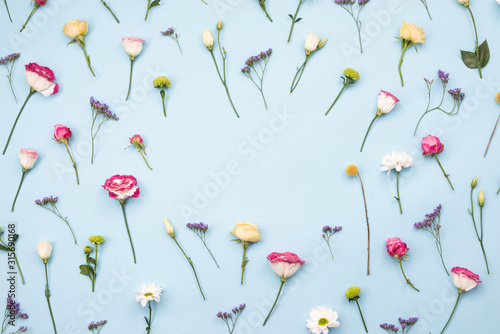 Multicolored flowers laid out flowers on a blue background