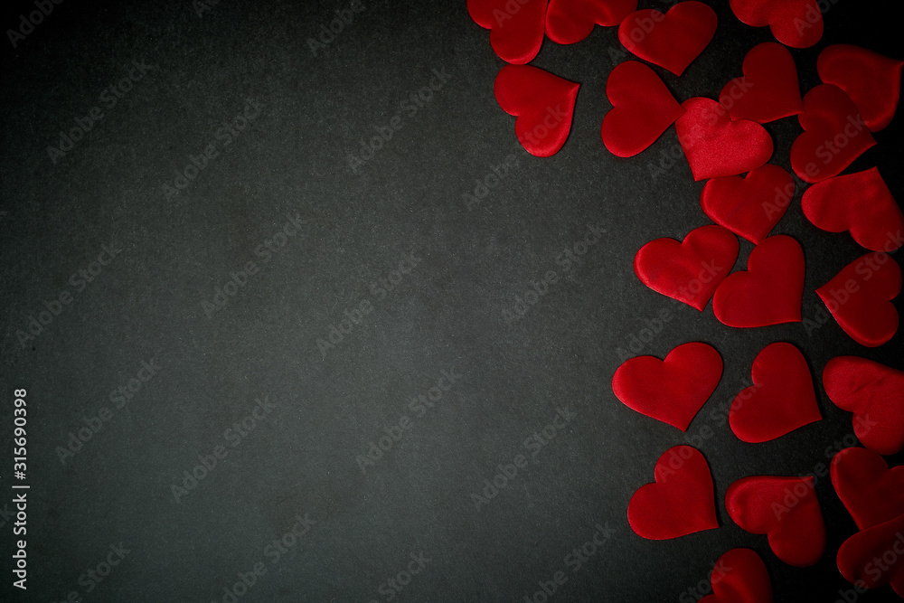 Valentine's day, a Declaration of love. Lots of red hearts on a dark graphite background. Valentine's day, a Declaration of love. Lots of red hearts on a dark graphite background.