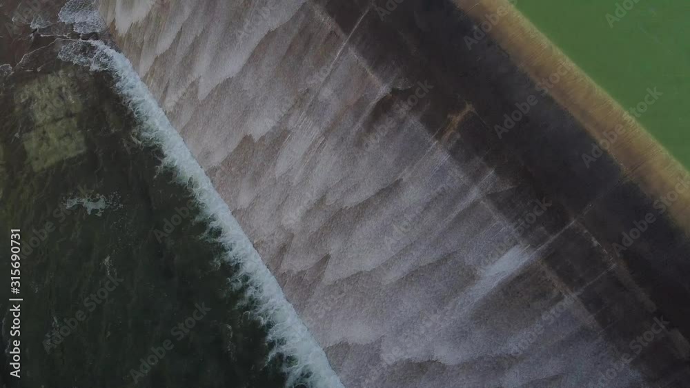 Water rushes over the walls of the Asprokremmos Dam as it overflows.