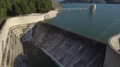 View of the Asprokremmos Dam reservoir overflowing with the bridge and control tower in the background. photo