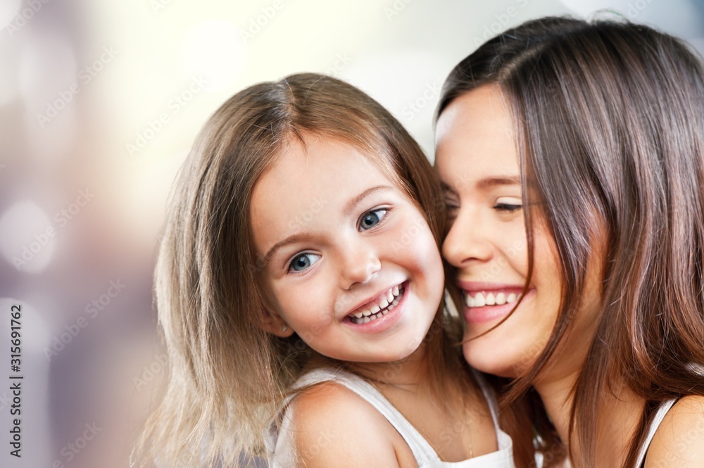 Happy Mother and daughter hugging on blur background Happy Mother and daughter hugging on blur background