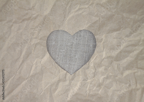 Flax heart on craft paper. Crumpled paper texture. Valentine s day stock photo for web  print and wallpaper. With empty space for text.