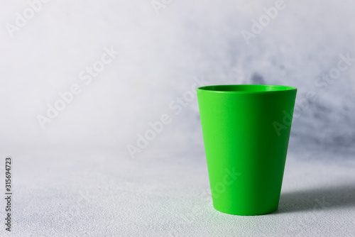 color plastic cups on gray stone background plastic waste