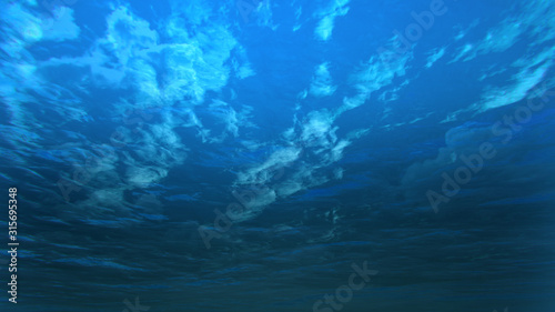 deep blue ocean with underwater angle by 3D rendering scene © RealCG