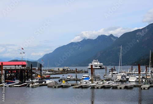 ferry arriving at Horseshoe Bay, boats and yachts moored at the marina; West Vancouver, BC Canada