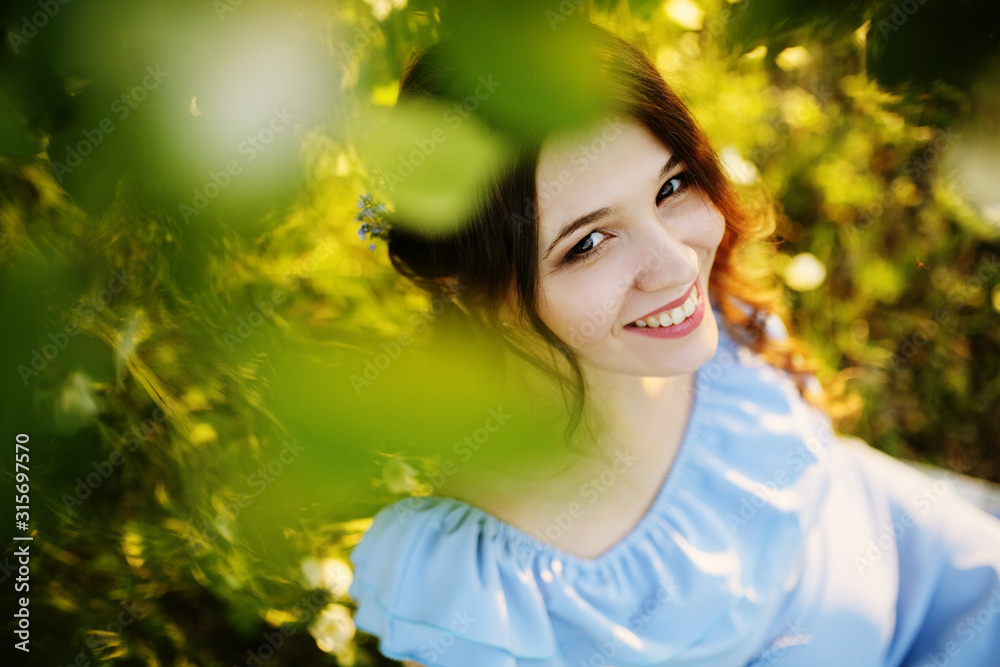 Girl in a flowering garden