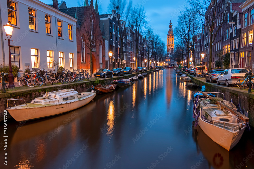 City scenic from Amsterdam with the Zuiderkerk in the Netherlands at twilight