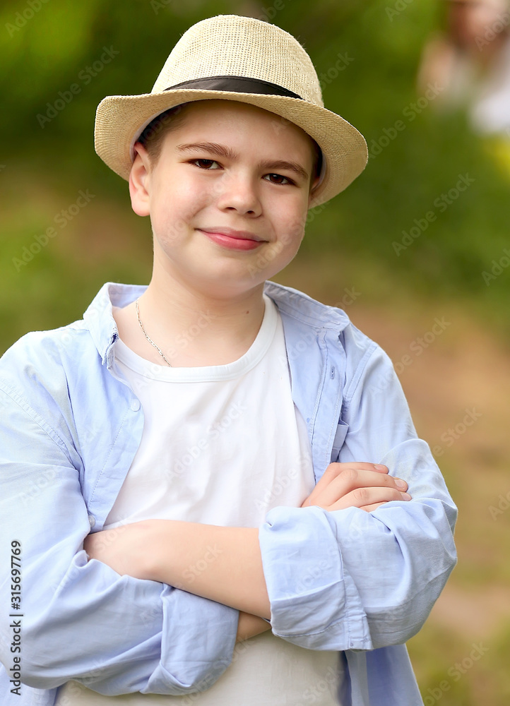 a boy in a hat walks in the spring botanical garden where flowers bloom