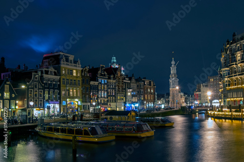 City scenic from Amsterdam by night with the Munt tower in the Netherlands