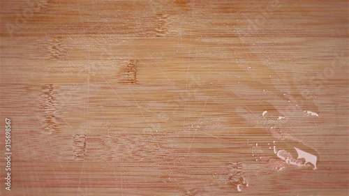 Grabbing cherry tomatoes from a wooden chopping board desktop