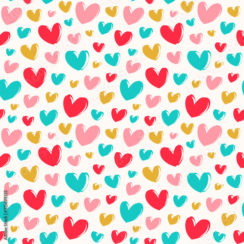 Seamless vector pattern with cute colorful hearts.