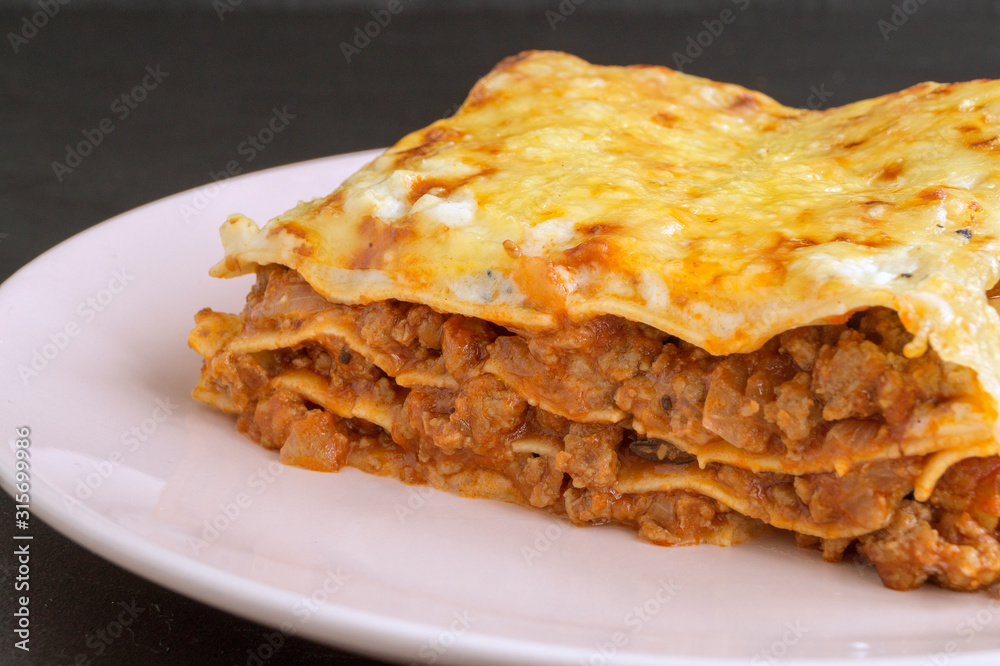 Meat lasagna on a wooden background. Meat lasagna on a wooden background.
