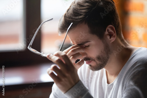 Bilde på lerret Exhausted male massage eyes suffering from headache