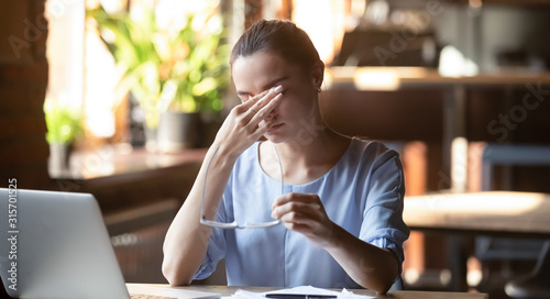 Cuadro en lienzo Exhausted female rubbing eyes suffering from blurry vision