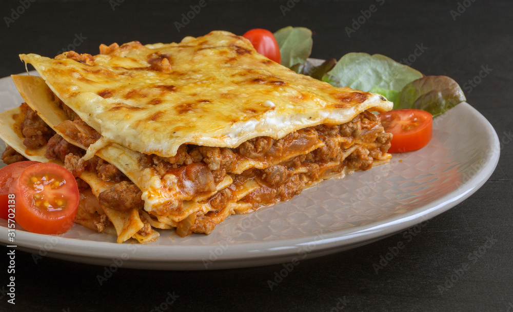 Meat lasagna on a wooden background. Meat lasagna on a wooden background.