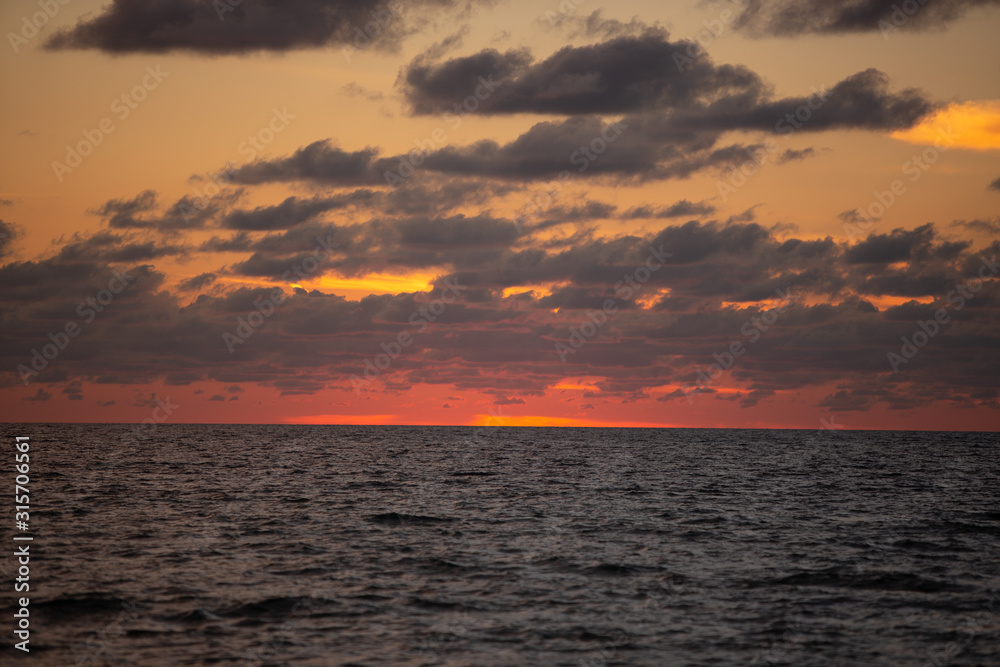 red golden ocean sunset with clouds