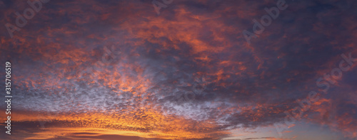 panorama of cloudscape at sunset with red clouds on sky photo