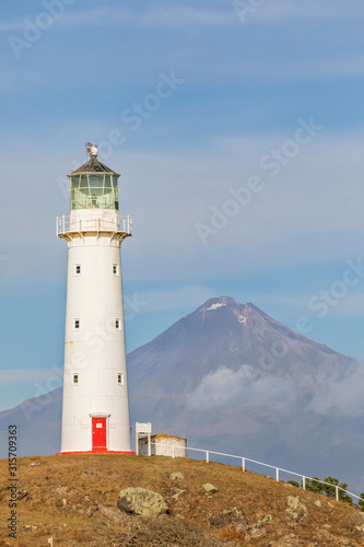 New Zealand, South Taranaki District, Pungarehu, Cape Egmont Lighthouse with Mount Taranaki volcano in background