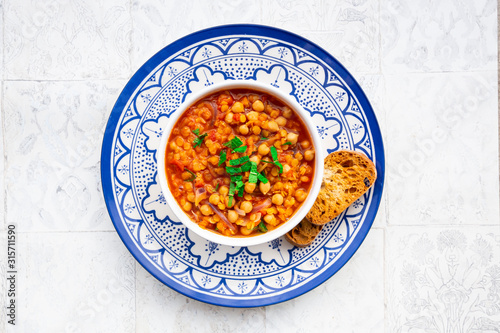 Lentil and chickpea soup (red lentils, chickpeas, tomatoes, red onions, mint) photo