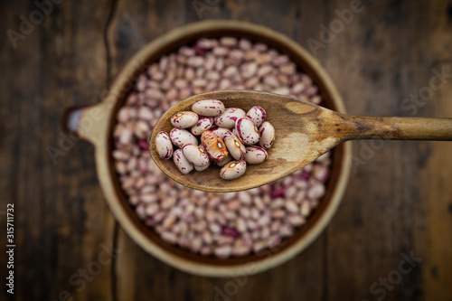 Spoon of dried pinto beans photo