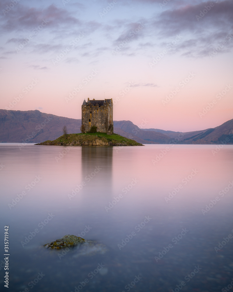 Very nice soft light at sunrise at Castle Stalker in the Scottish Highlands. Castle Stalker is a very famous castle in Scotland, and at high tide it is completely surrounded by water.