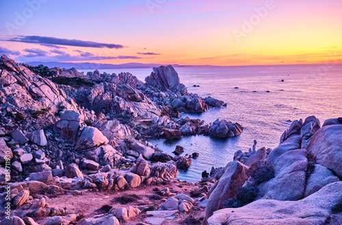 Italy, Province of Sassari, Santa Teresa Gallura, Rocky shore of Cape Testa at purple dusk photo