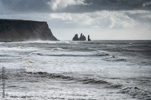 Photos volcanic rock formation of Dyrholaey near Vik in stormy weather southern Iceland