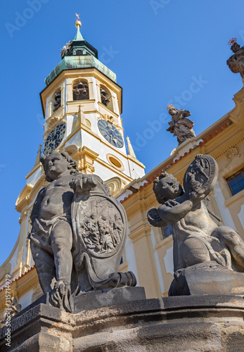 Photography PRAGUE, CZECH REPUBLIC - OCTOBER 14, 2018: The baroque angel before facade of Loreto church  - designed by Kilian Ignac (1772)