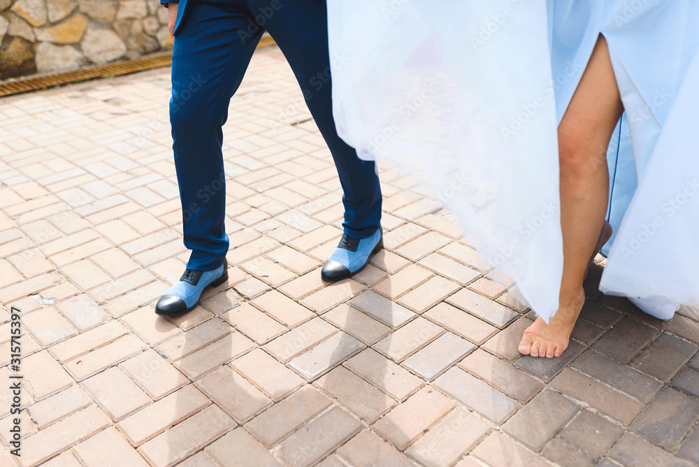 man in blue shoes and barefooted woman man in blue shoes and barefooted woman