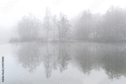 Fog over the pond on the field in Ardooie in West Flanders