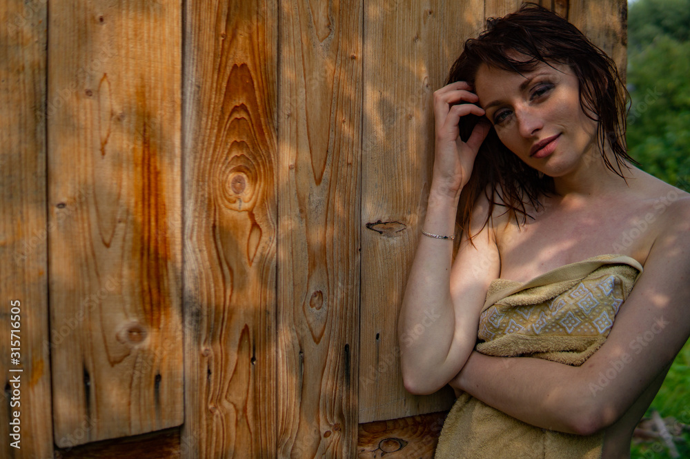 Fototapeta premium nude woman, wet red hair, nature, towel