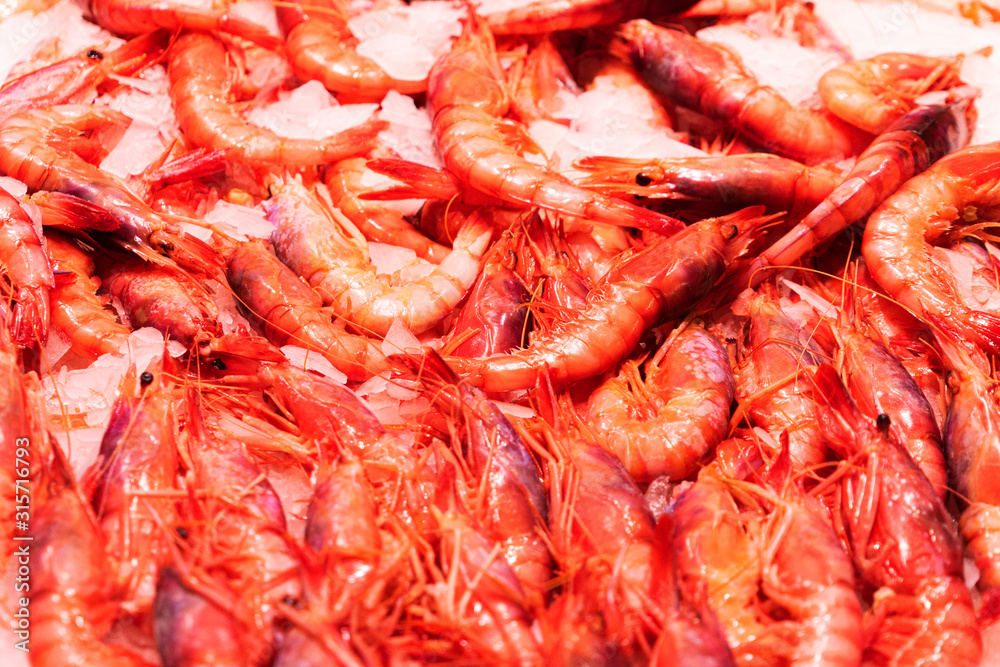 Top view to shrimps on display on ice in fisherman market store in Spanish market