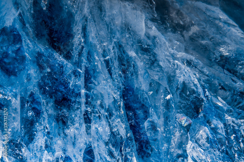 A close up macro photograph of a cut and polished blue agate crystal stone geode texture