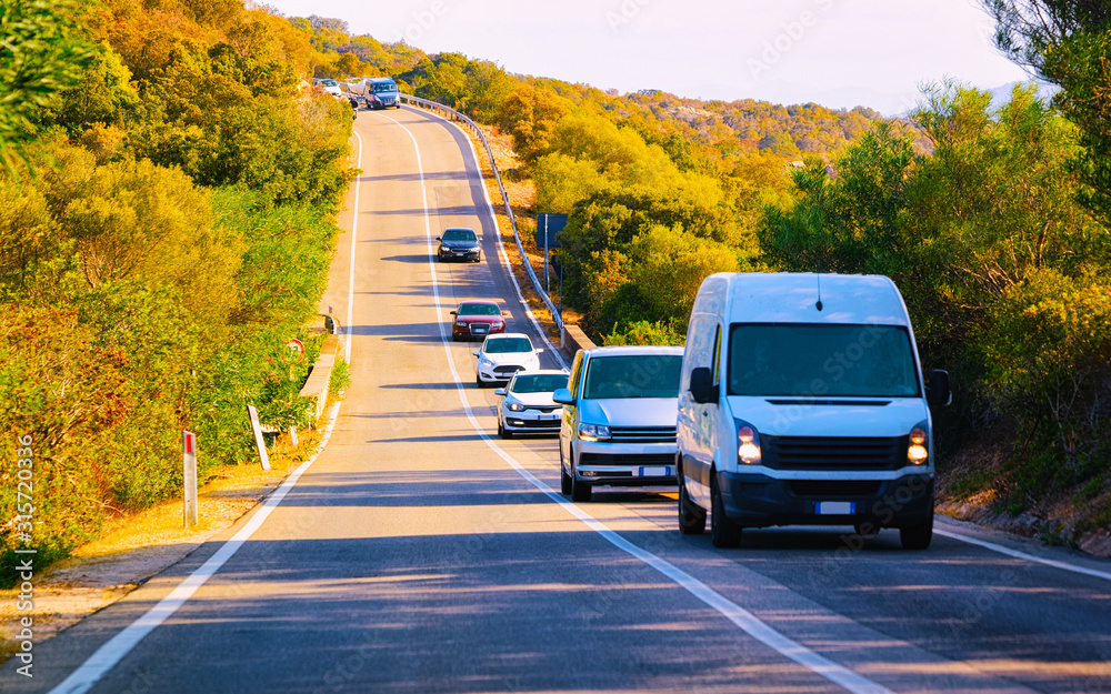 Φωτογραφία Minivan and cars on road at at Mediterranean Sea in Sardinia Island, Italy summer