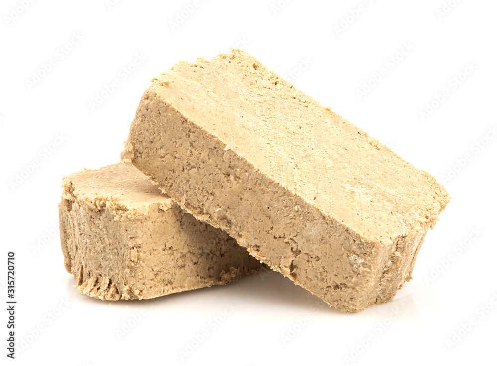 Sunflower halva isolated on white background. Sweet halva dessert slices. Sunflower halva isolated on white background. Sweet halva dessert slices.