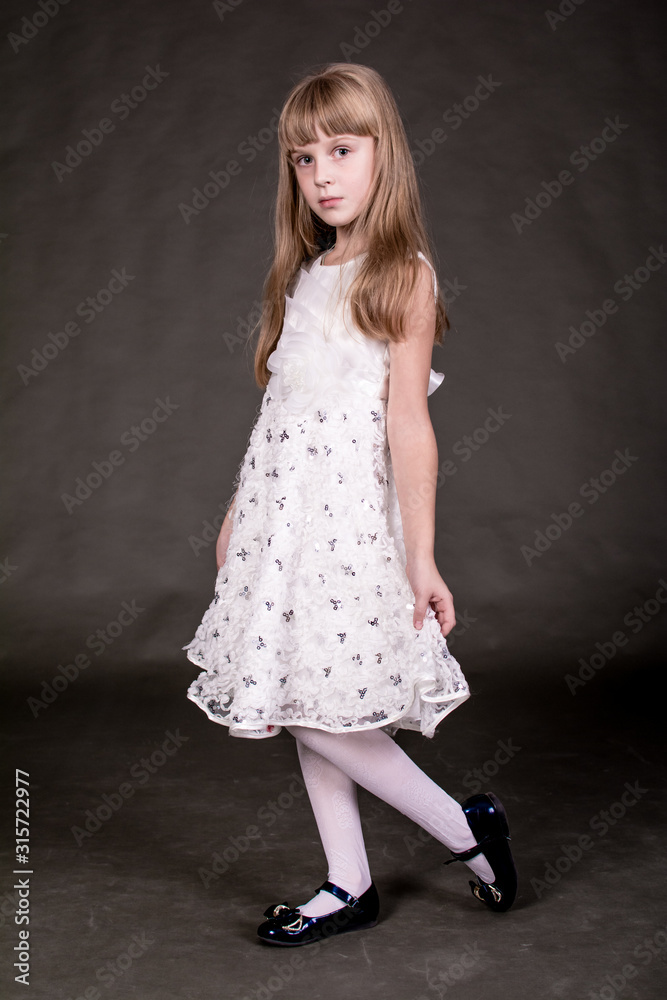 Portrait of a girl in a beautiful dress on a dark background. Portrait of a girl in a beautiful dress on a dark background.