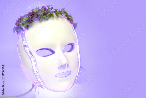 Color therapy mask glowing light purple, flowers