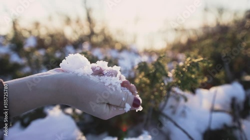 hand touching and playing with the snow