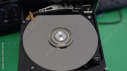 Boot read head on computer hard drive. Computer hard drive, open, read / write head and hard drive.