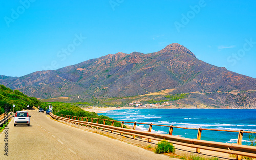 Car at the road at Carbonia with Mediterranean Sea in Sardinia Island in Italy summer. Transport driving on highway of Europe. Holiday View on motorway. Cagliari province. Mixed media.